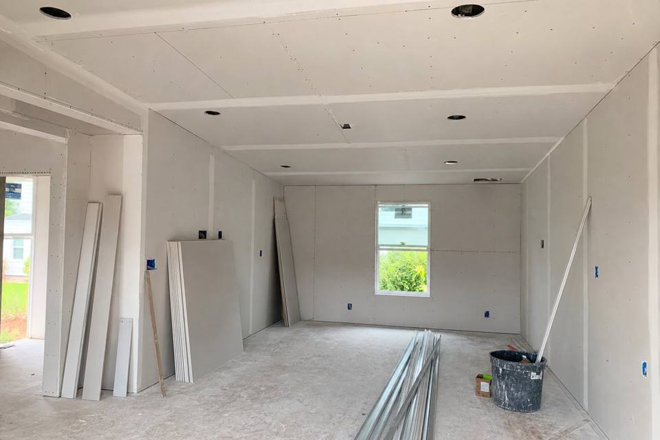 New sheetrock hung in a Brevard County room addition awaiting taping and finishing