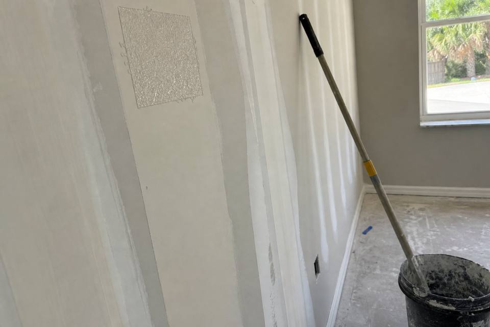 Taped drywall seams with feathered joint compound during finishing in a Brevard County home